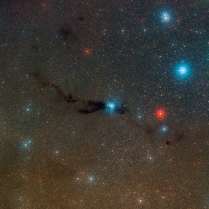 Vista grande angular da nuvem escura Lupus 3 e das estrelas quentes jovens associadas à nuvem