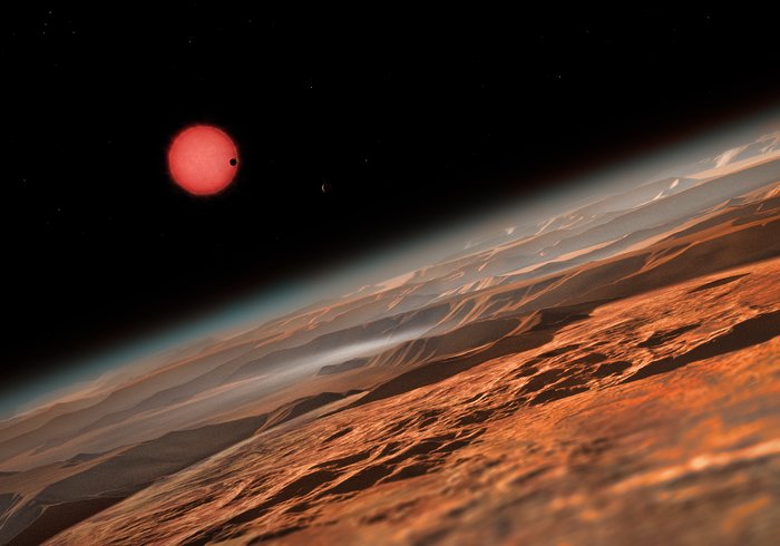 Künstlerische Darstellung des sehr kühlen Zwergsterns TRAPPIST-1 aus der Nähe eines seiner Planeten