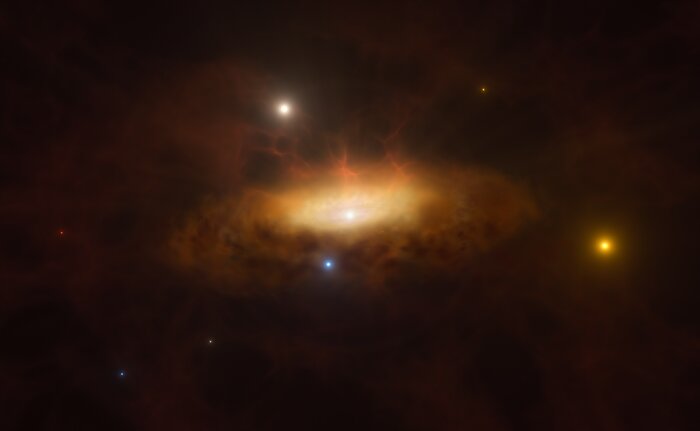 This artist’s impression shows a ring of dark yellow clouds surrounding a brighter yellow region, with an especially bright white dot at its centre, on a dark background. Bright yellow, red, white, and blue stars dot the image.